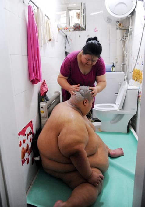 A Fire Brigade Bathe Obese Man In China